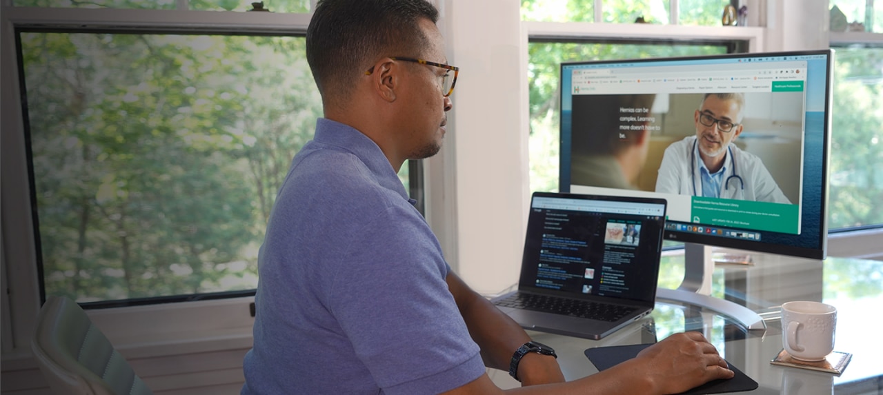 Patient on home computer researching Hernia Info