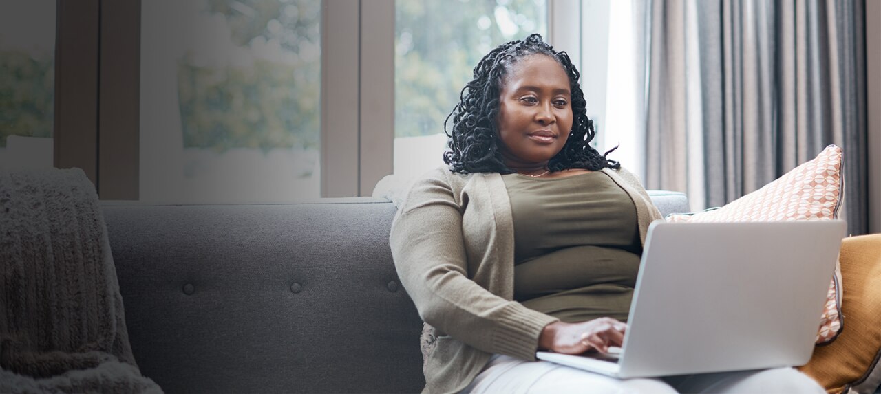 Female patient researching at home on laptop