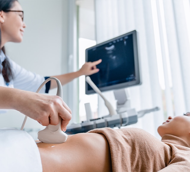 Female sonographer giving female patient an ultrasound scan