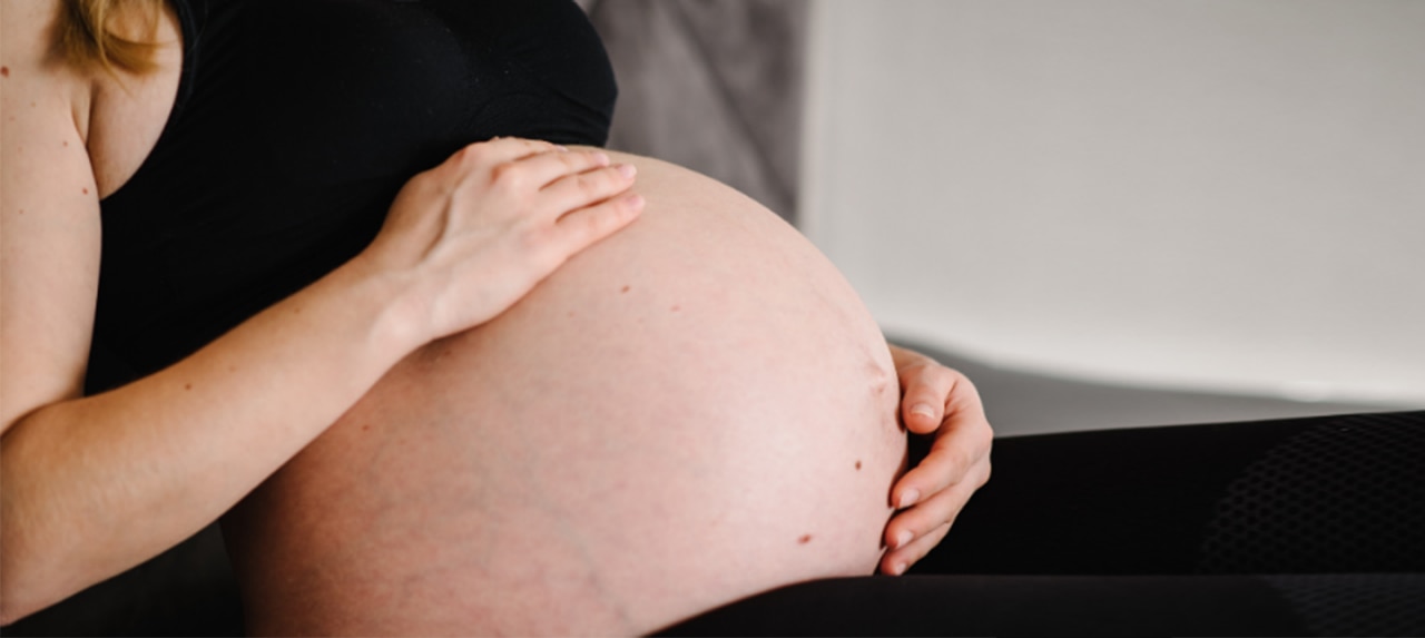 Pregnant woman holding her stomach