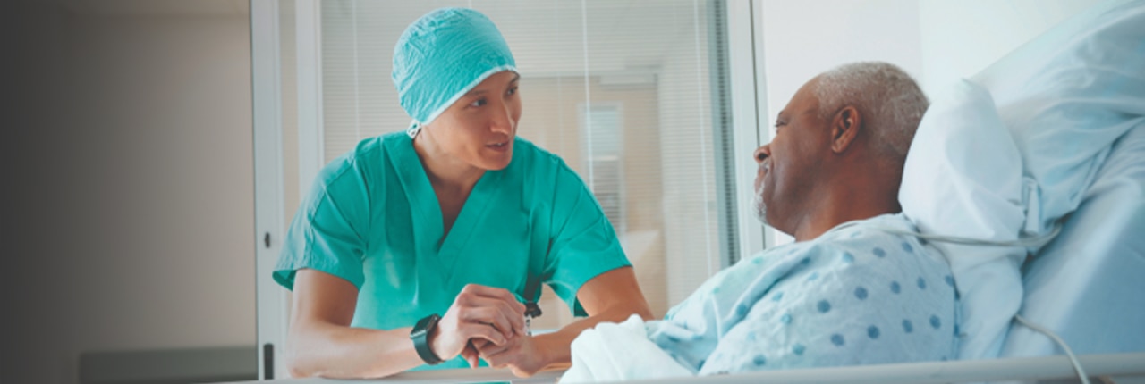Black male hernia patient speaking to surgeon post-operation