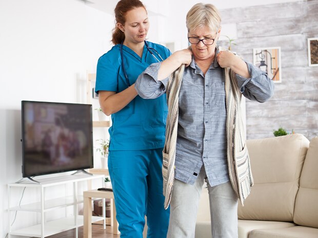 Woman getting dressed in loose clothing with a hernia