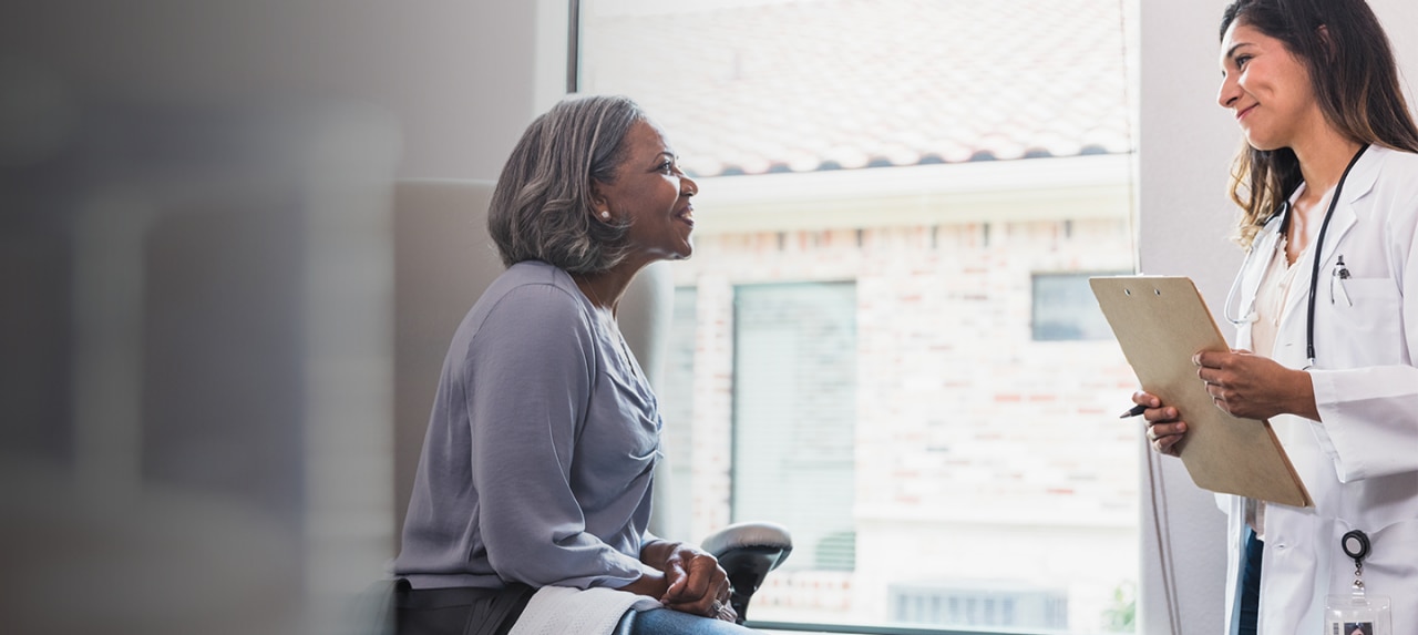 Elderly female patient in doctor's office during consultation.